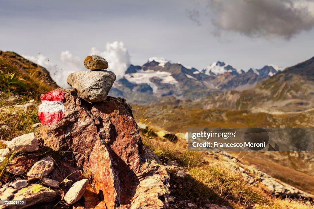 Stack of painted rocks, view of mountains