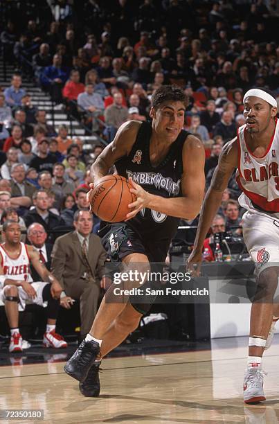 Guard Wally Szczerbiak of the Minnesota Timberwolves dribbles the ball as forward Rasheed Wallace of the Portland Trail Blazers plays defense during...