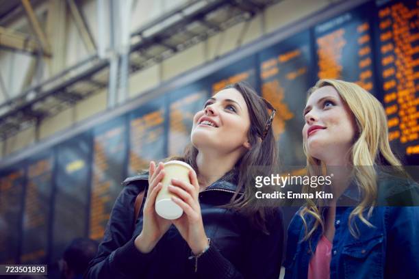 women looking at departure information, london, uk - for sale frase en inglés fotografías e imágenes de stock