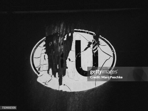 close-up of damaged oval sticker - letter u stock pictures, royalty-free photos & images