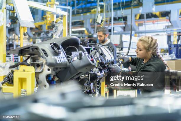 female apprentice engineer on production line in car factory - dashboard vehicle part imagens e fotografias de stock