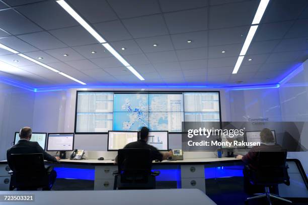 operators in automotive emergency response control room in car factory - kontrollrum bildbanksfoton och bilder