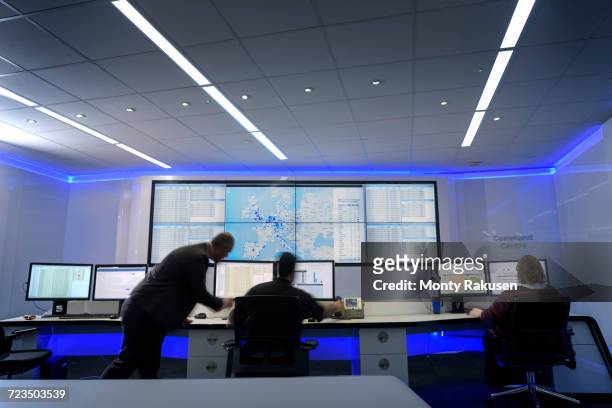 operators in automotive emergency response control room in car factory - control center stock pictures, royalty-free photos & images
