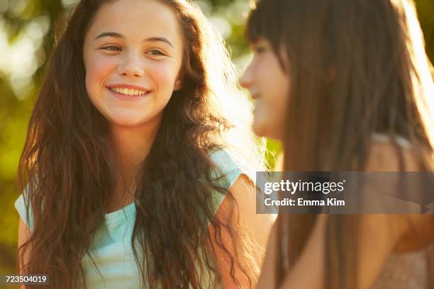 two young girls in park - only girls fotografías e imágenes de stock