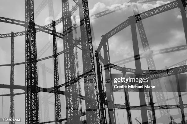 multi-layered image of hackney gasometer, london, england, uk - gasbehälter stock-fotos und bilder