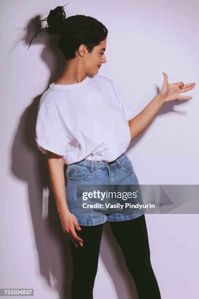 beautiful fashion model making dog shadow on white wall - shadow puppets stock pictures, royalty-free photos & images