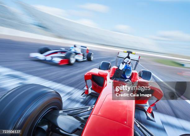 open-wheel single-seater racing car race car crossing finish line on sports track - sports car photos et images de collection