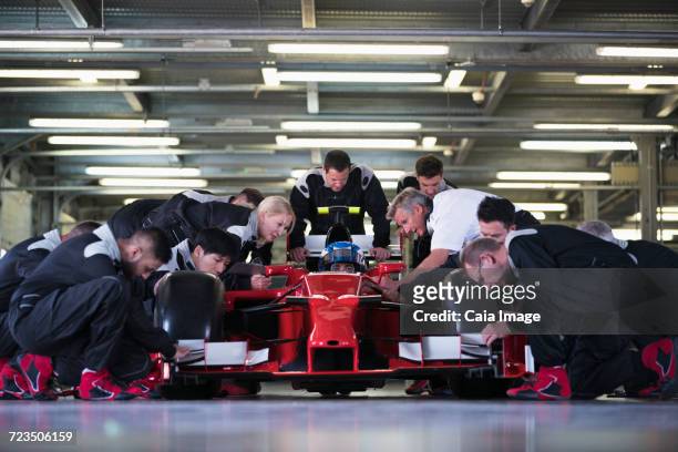 pit crew preparing open-wheel single-seater racing car race car and driver in repair garage - pitstop team stock pictures, royalty-free photos & images