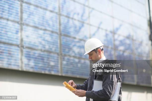 male engineer using multimeter on solar panel site - multimeter stock pictures, royalty-free photos & images
