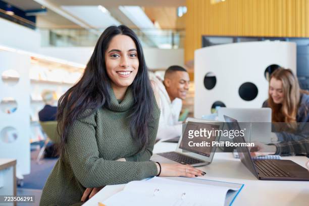 university students using laptops and digital tablet, working together - university student portrait stockfoto's en -beelden