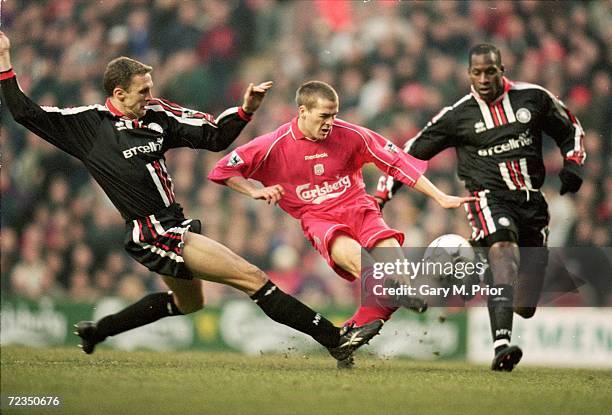 Michael Owen of Liverpool is closed down by Steve Vickers and Ugo Ehiogu of Middlesbrough during the FA Carling Premier League match played at...