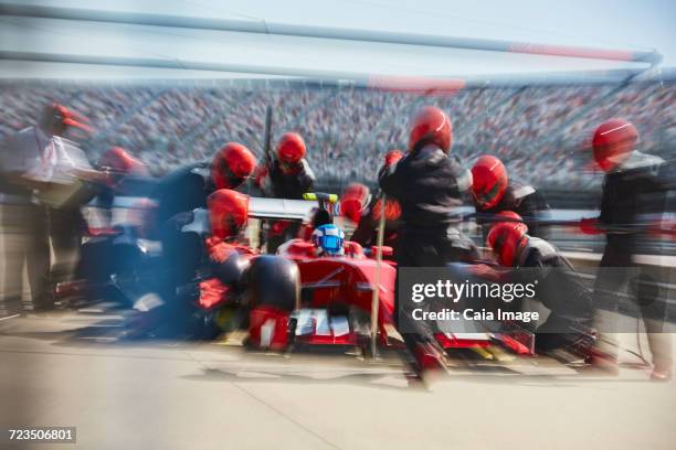 pit crew replacing tires on open-wheel single-seater racing car race car in pit lane - qualifying race 28 stock pictures, royalty-free photos & images