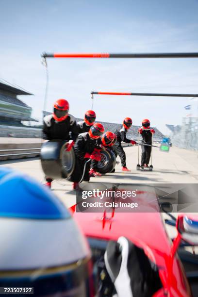 pit crew with tires ready for nearing open-wheel single-seater racing car race car in pit lane - qualifying race 28 stock pictures, royalty-free photos & images