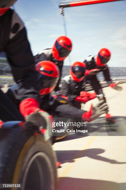 pit crew with tires ready in pit lane - qualifying race 28 stock pictures, royalty-free photos & images