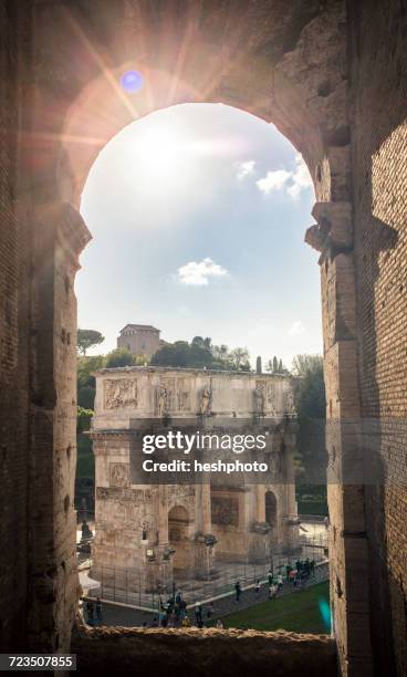sunlit view from colosseum of the arch of constantine, rome, italy - fórum romano imagens e fotografias de stock