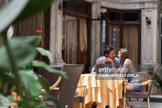young couple sitting outside cafe, turin, piedmont, italy - romantic table for two stock pictures, royalty-free photos & images