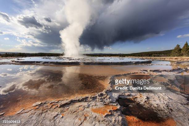 stormy clouds over great fountain geyser, yellowstone national park, wyoming, usa - great fountain geyser stock pictures, royalty-free photos & images