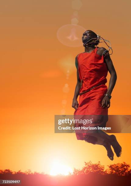 masai man jumping while performing a masai traditional dance, masai mara national reserve, kenya - masai mara national reserve stock pictures, royalty-free photos & images