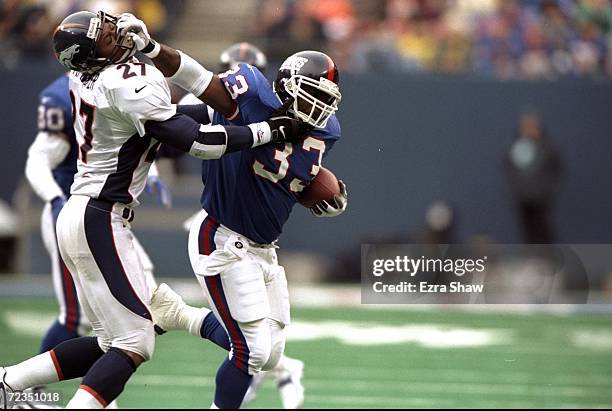 Running back Gary Brown of the New York Giants in action against safety Steve Atwater of the Denver Broncos during the game at Giants Stadium in East...