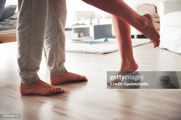 couple standing face to face, woman leaning into man, low section - feet kiss stockfoto's en -beelden