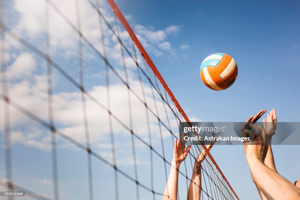 Cropped image of people Volleyball at beach