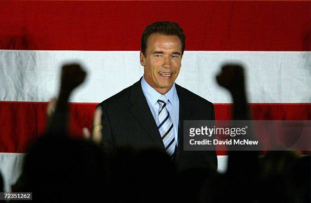 California Governor-elect Arnold Schwarzenegger arrives to introduce U.S. President George W. Bush October 16, 2003 in San Bernardino, California....