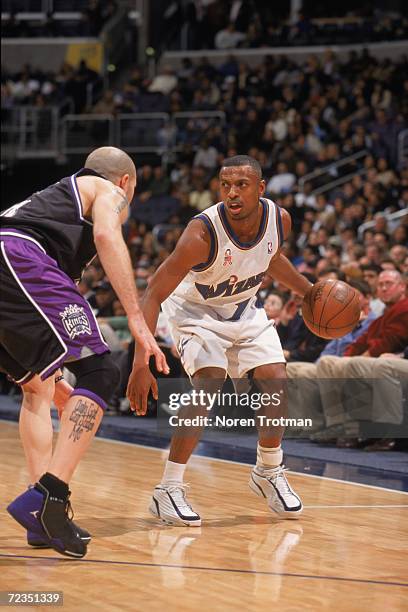 Guard Chris Whitney of the Washington Wizards dribbles the ball as point gaurd Mike Bibby of the Sacramento Kings plays defense during the NBA game...