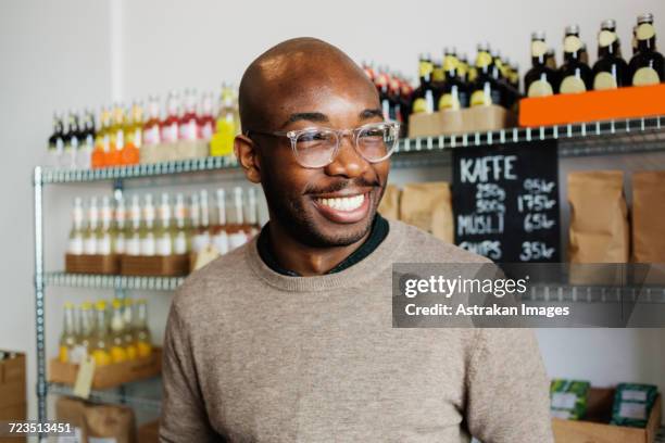 happy young man looking away at coffee shop - one man only stock pictures, royalty-free photos & images