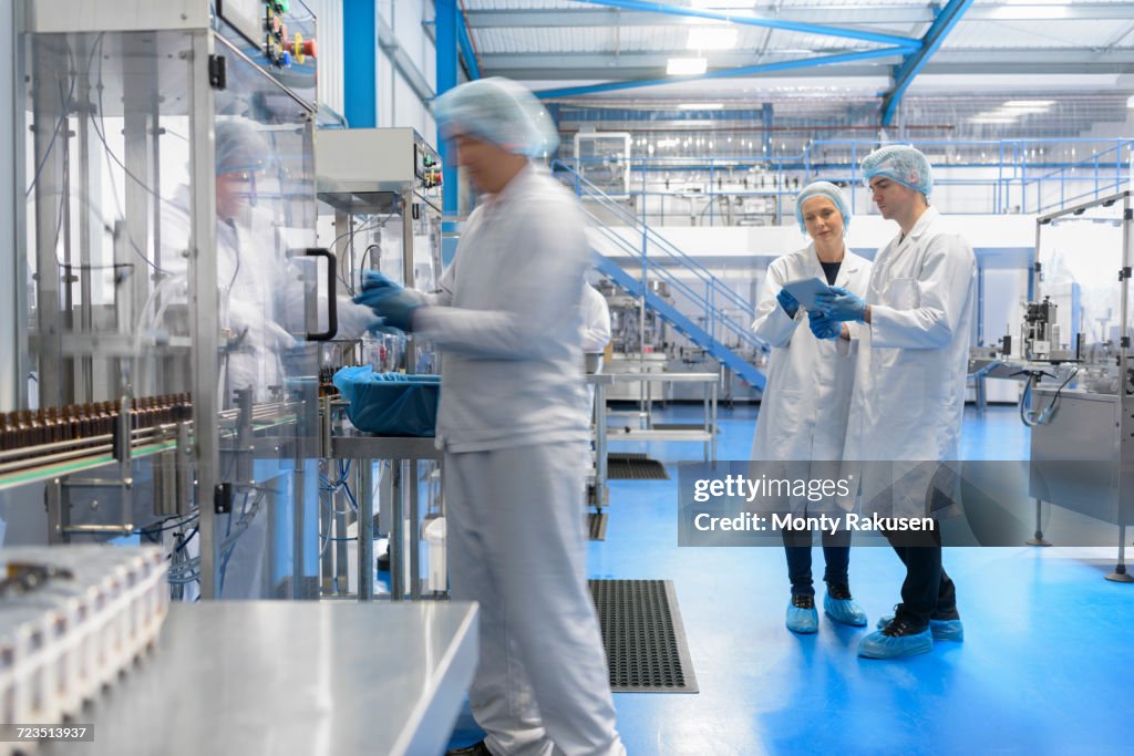 Worker on packing line in pharmaceutical factory