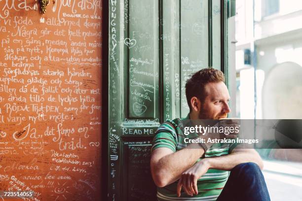 sweden, stockholm, gamla stan, man holding coffee cup in cafe - fika stock pictures, royalty-free photos & images