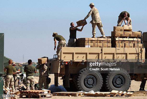 Marines from 3rd Battallion 1st Marine Division unload newly arrived supplies and equipment February 1, 2003 at Living Support Area 7 near the Iraqi...