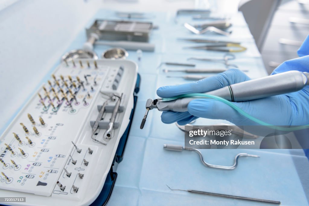 Dentist holding drill in dental surgery, close up