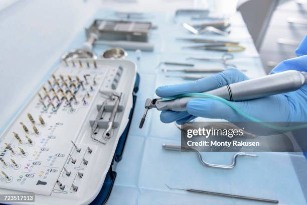 dentist holding drill in dental surgery, close up - dental drill stock pictures, royalty-free photos & images