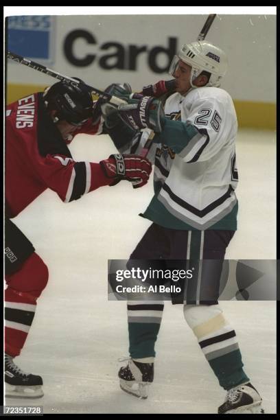 Terry Yake of the Anaheim Mighty Ducks and defenseman Scott Stevens of the New Jersey Devils fight during a game at Arrowhead Pond in Anaheim,...
