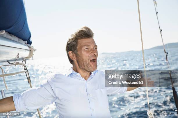 portrait of screaming man on his sailing boat - male sailing stock pictures, royalty-free photos & images