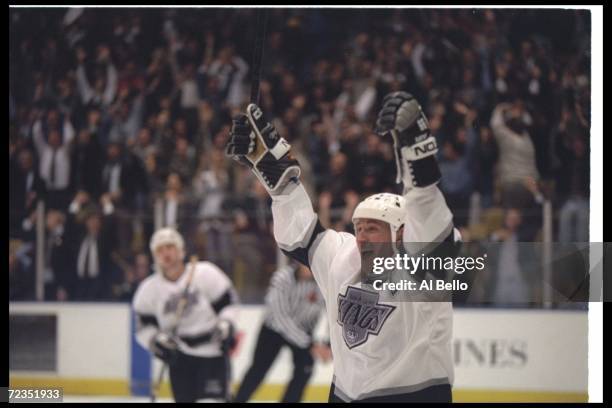 Center Wayne Gretzky of the Los Angeles Kings celebrates after scoring goal 802, breaking Gordie Howe's all-time scoring record of 801, during the...
