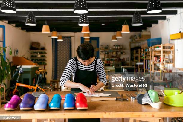 clogmaker working in her workshop - footwear manufacturing stock pictures, royalty-free photos & images