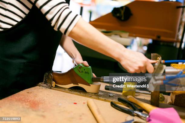 close-up of clogmaker working in her workshop - clogs stock pictures, royalty-free photos & images