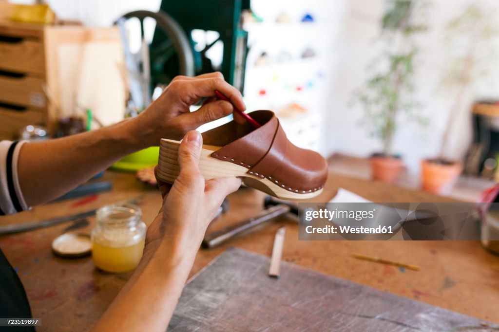 Close-up of clogmaker working in her workshop