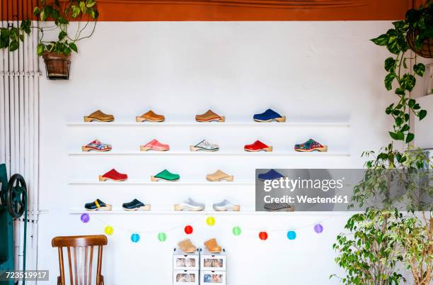 assortment of clogs on shelf - shoes in a row stock pictures, royalty-free photos & images