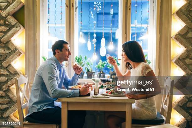 couple having dinner in a restaurant - table side view stock pictures, royalty-free photos & images