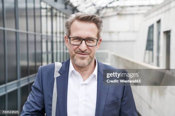 portrait of smiling businessman with stubble wearing glasses - jacket stock pictures, royalty-free photos & images