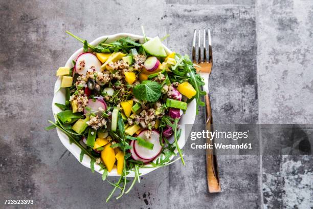 mango quinoa salad with rocket, avocado, cucumber, red radishes and pumpkin seeds - quinoa salad stock pictures, royalty-free photos & images