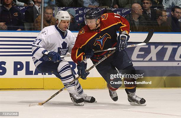 Ilya Kovalchuk of the Atlanta Thrashers is pressured by Shayne Corson of the Toronto Maple Leafs during the game against at the Air Canada Center in...