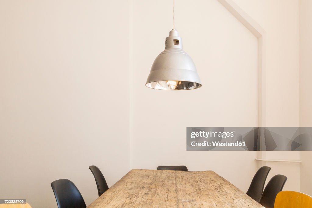 Conference table and ceiling light in a loft