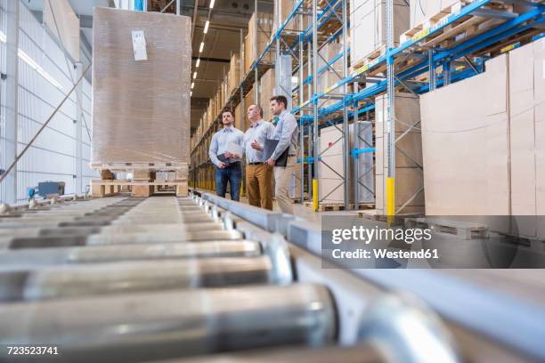 three men talking in factory warehouse - factory ipad stock pictures, royalty-free photos & images