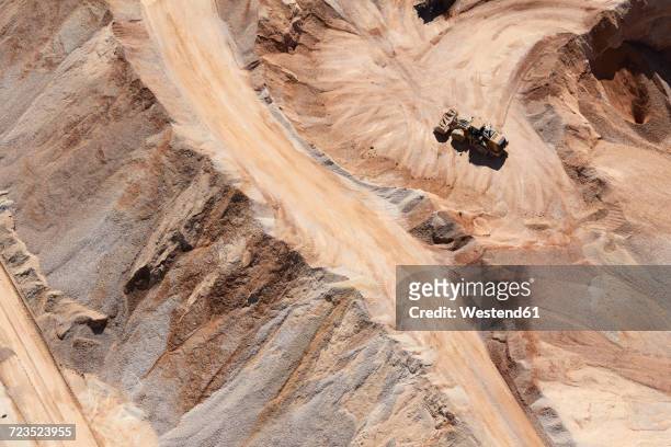 USA, Texas, aerial view of sand mine near San Antonio with a grader moving sand