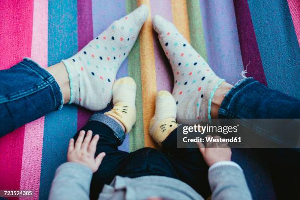 feet of mother and baby girl on a hammock - stocking feet fotografías e imágenes de stock