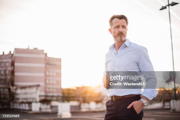 portrait of mature man looking at distance - three quarter length stock pictures, royalty-free photos & images