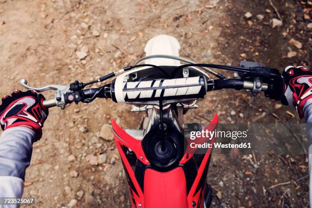 bilker holding handlebar of his motor bike, close up - motocross fotografías e imágenes de stock